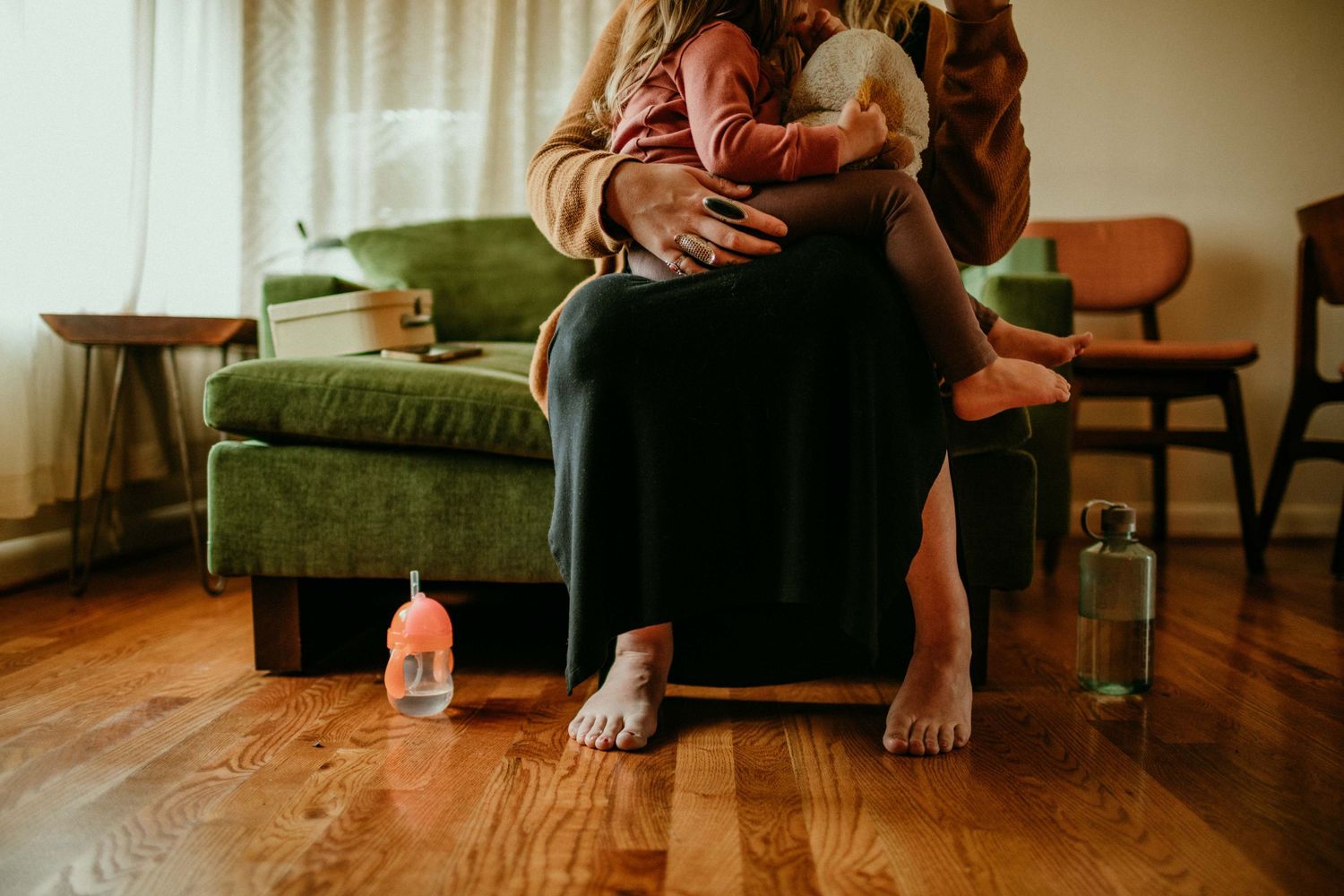 cropped image of mother and childs feet/legs sitting on couch. portland, oregon family photographer rushes & waves