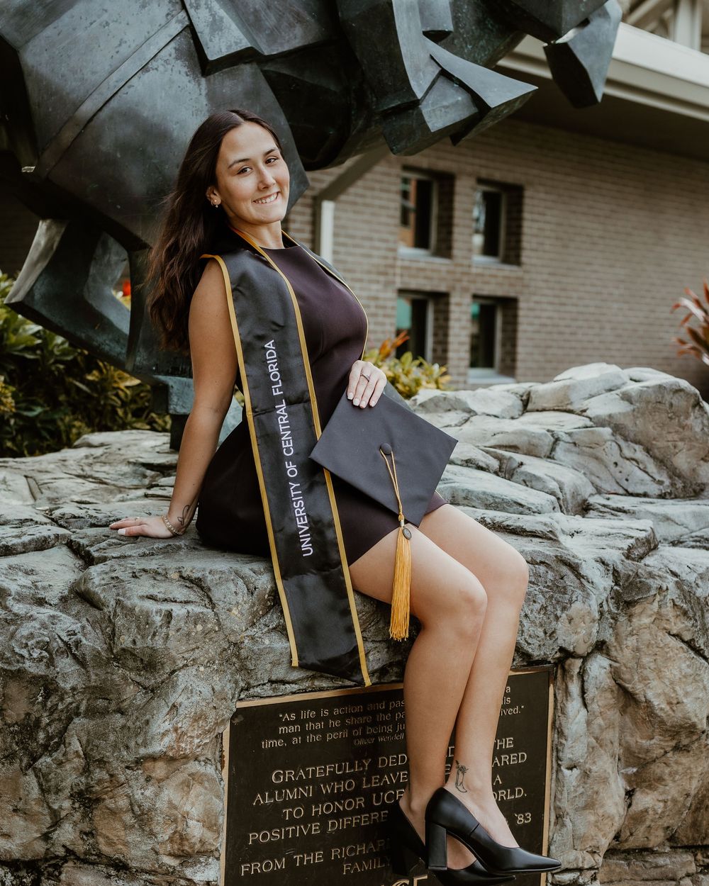 Graduation photos featuring cap and gown details against stone wall backdrop.