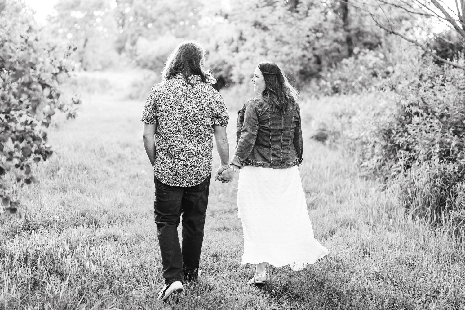 Engaged couple laughing and playfully interacting during their Kenosha engagement session.