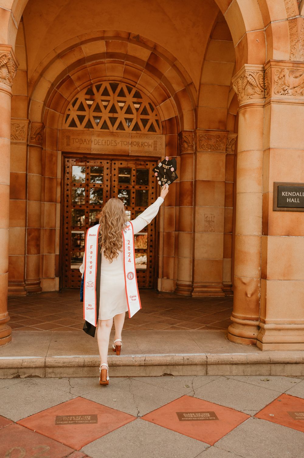 Architectural details of a historic university building with arched columns and terracotta floors.