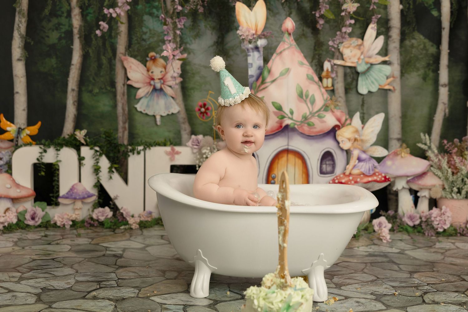 Whimsical fairy-themed photo setup featuring a white bathtub, woodland backdrop, and magical decorative elements.