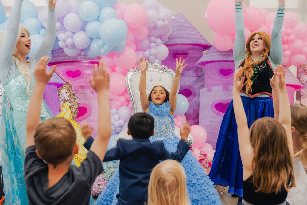7th birthday celebrant dancing with Elsa and Ana.