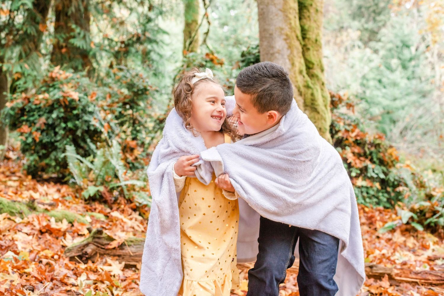 Candid family moments captured in a series of outdoor fall photos with joyful expressions.