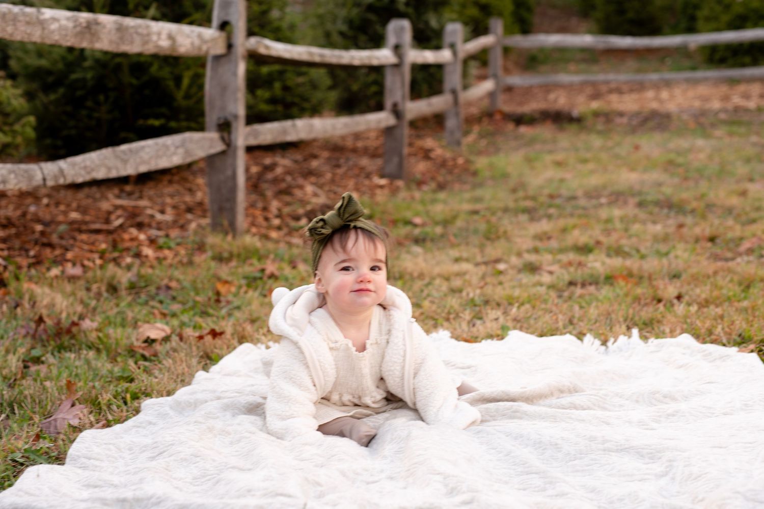 A collection of candid lifestyle photos showing a baby lying on a white blanket outdoors in a natural setting.
