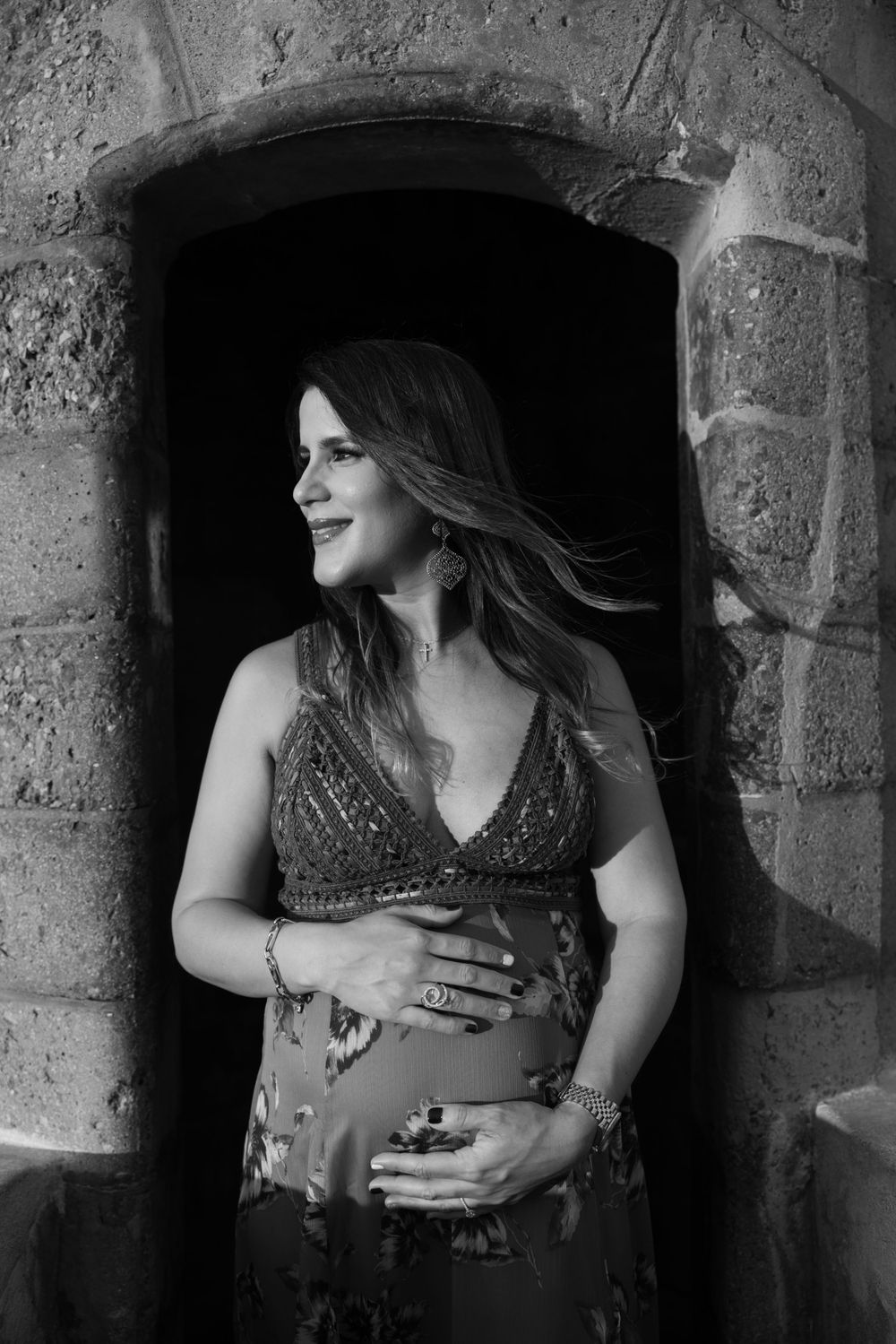 Maternity photo of an expectant mother in a stone archway.