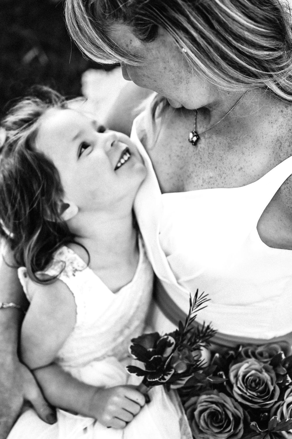 Little girl embracing her momma at wedding anniversary.
