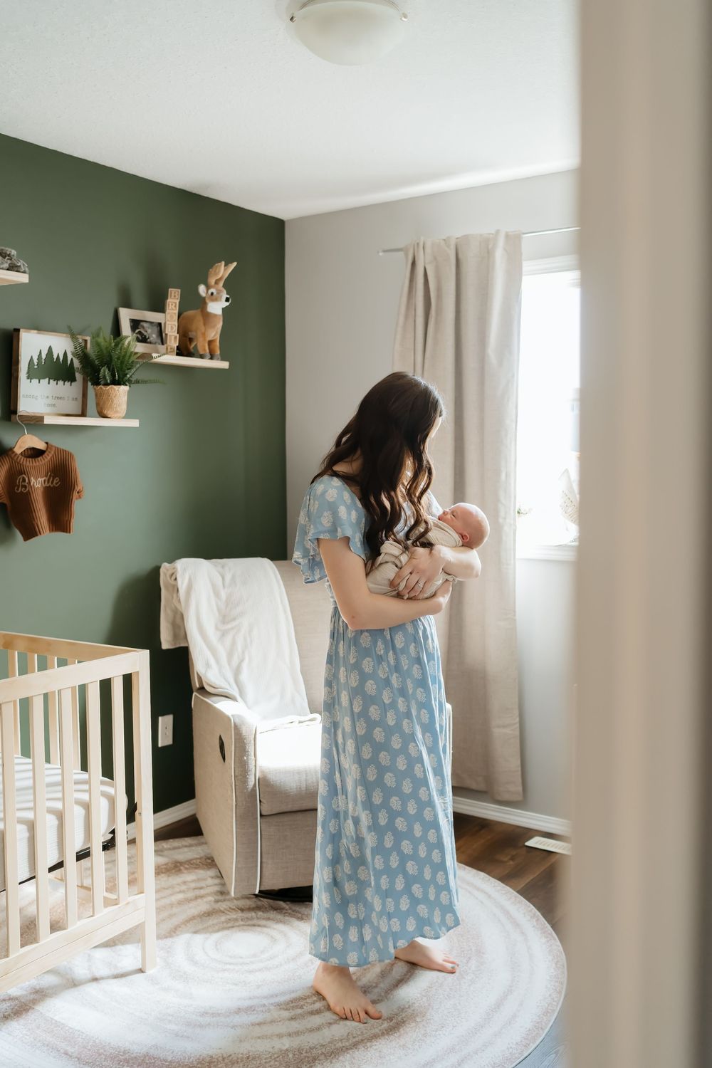 Series of playful moments in a nursery with sage green accent wall and white crib.