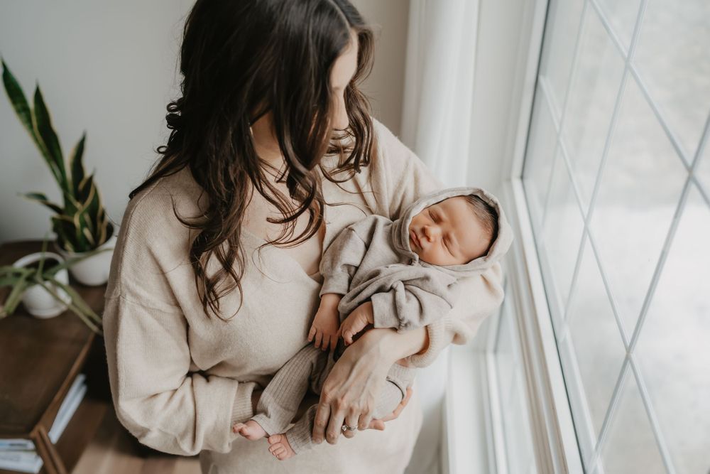 Soft natural light portrait session with baby by window.