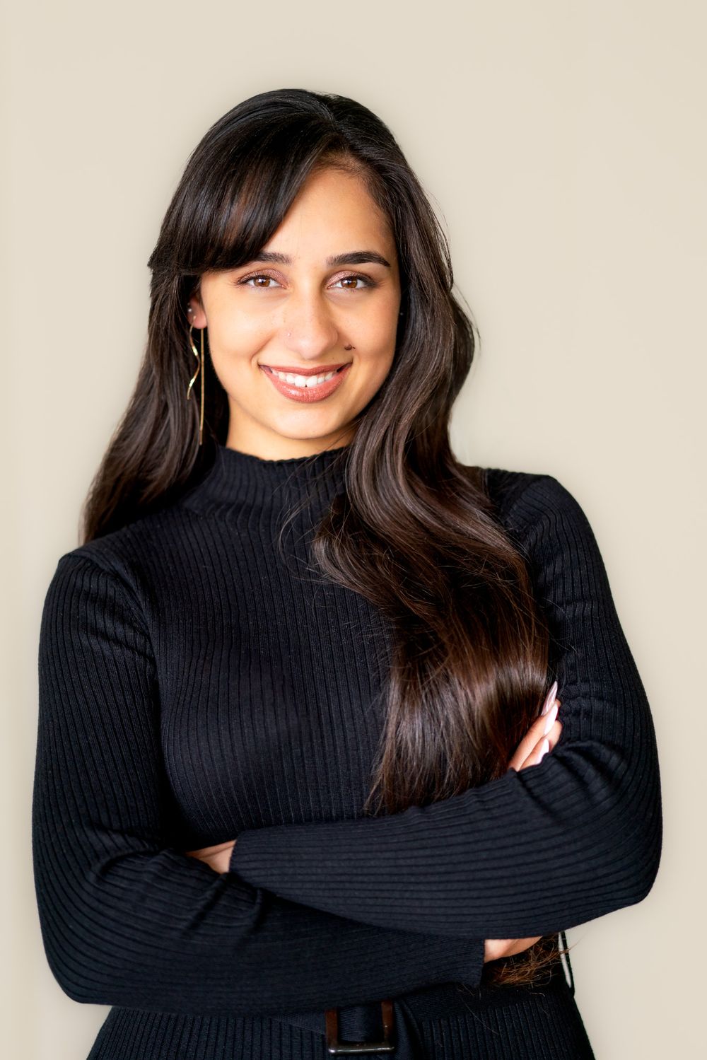 Person wearing a black turtleneck sweater poses in a series of candid expressions against a light background.