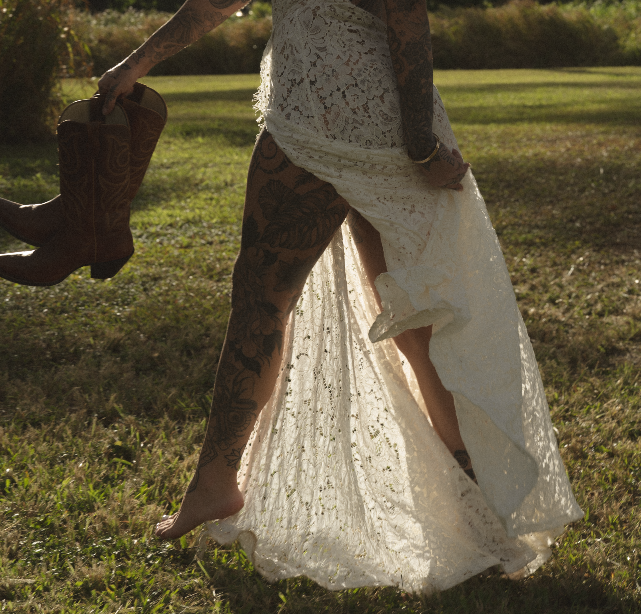 A wedding dress twirls gracefully in a sunlit outdoor setting, creating a dreamy spinning motion effect.