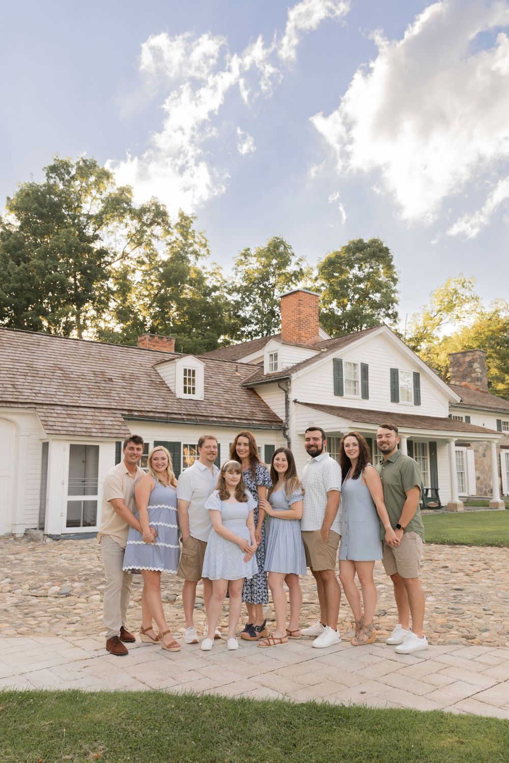 family posing for a photo in front of van hoosen house in rochester