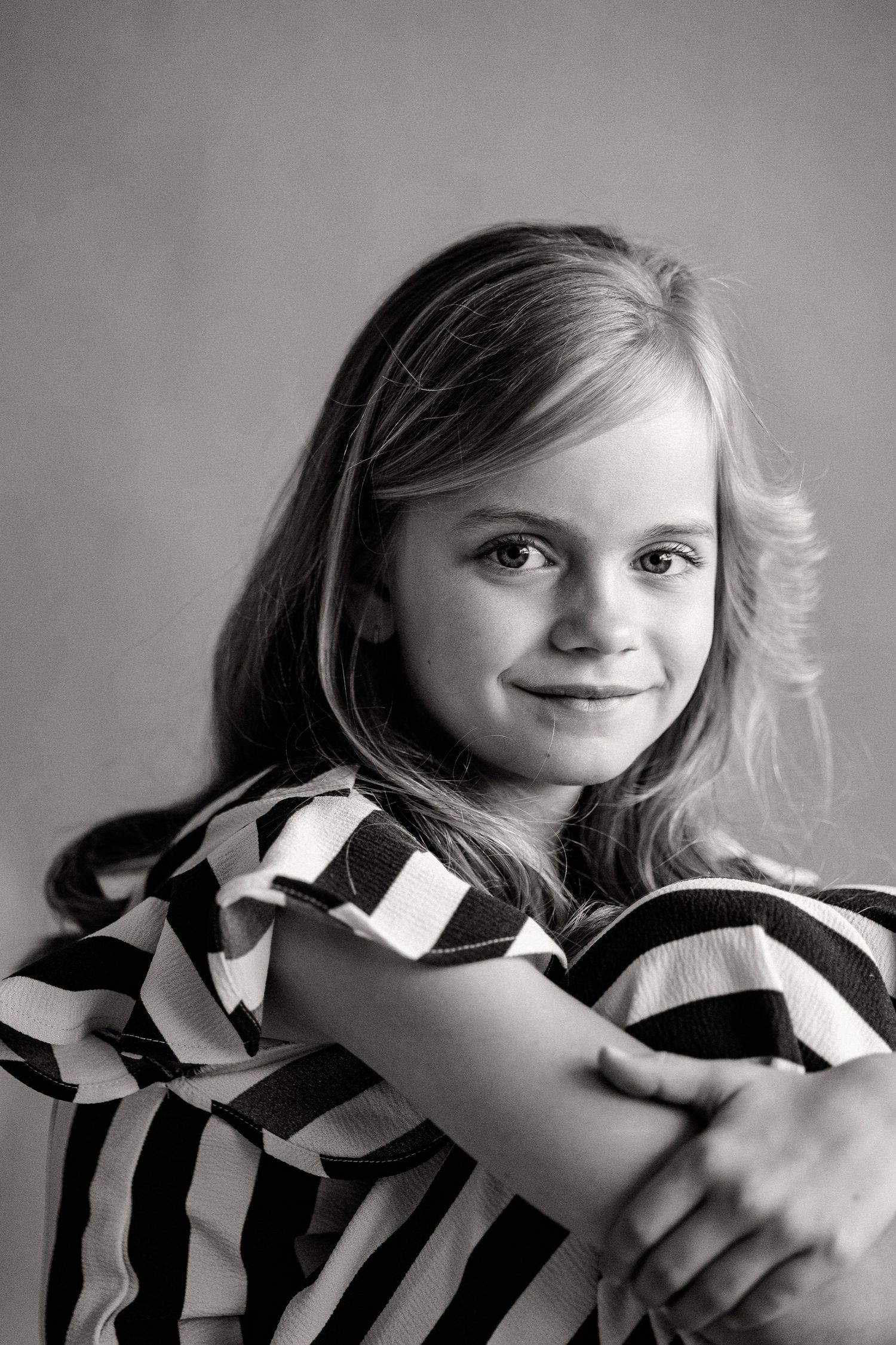 Black and white series showing expressive poses in striped clothing.