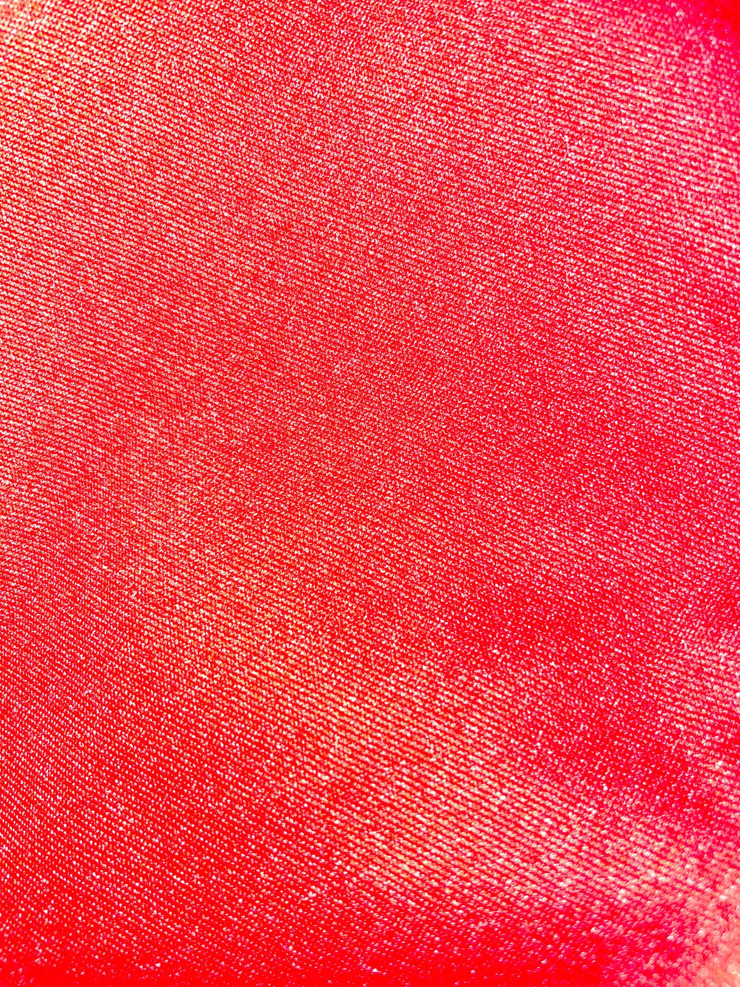 Bright red textured fabric background with diagonal lines.
