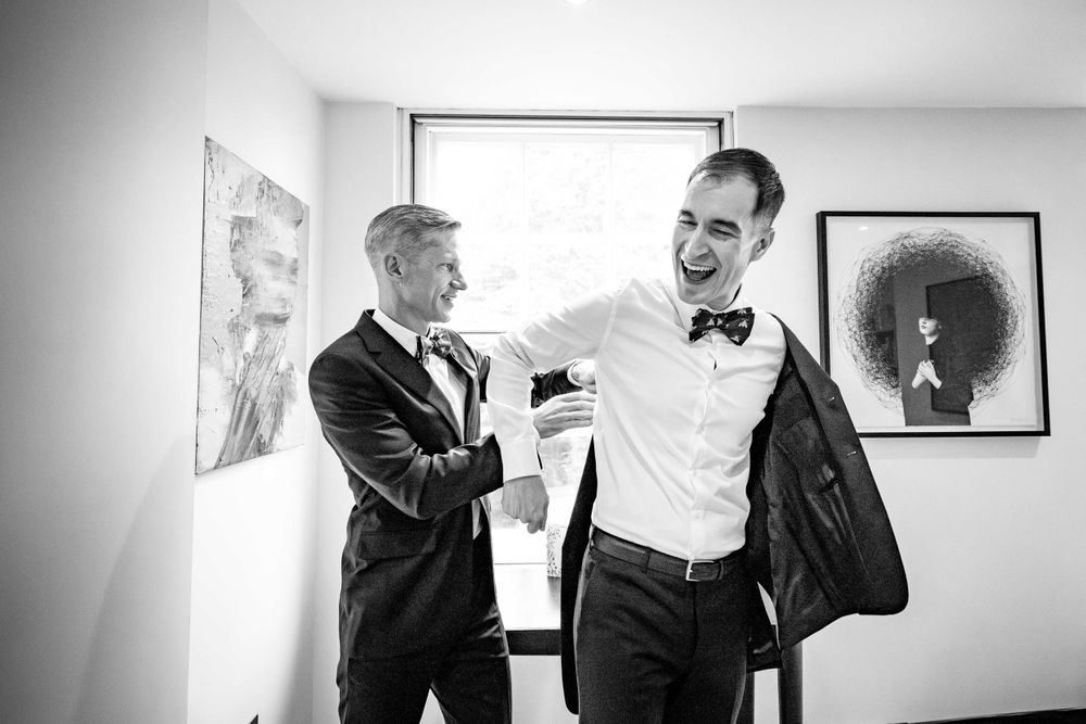 Black and white photo of formal wear preparation indoors.