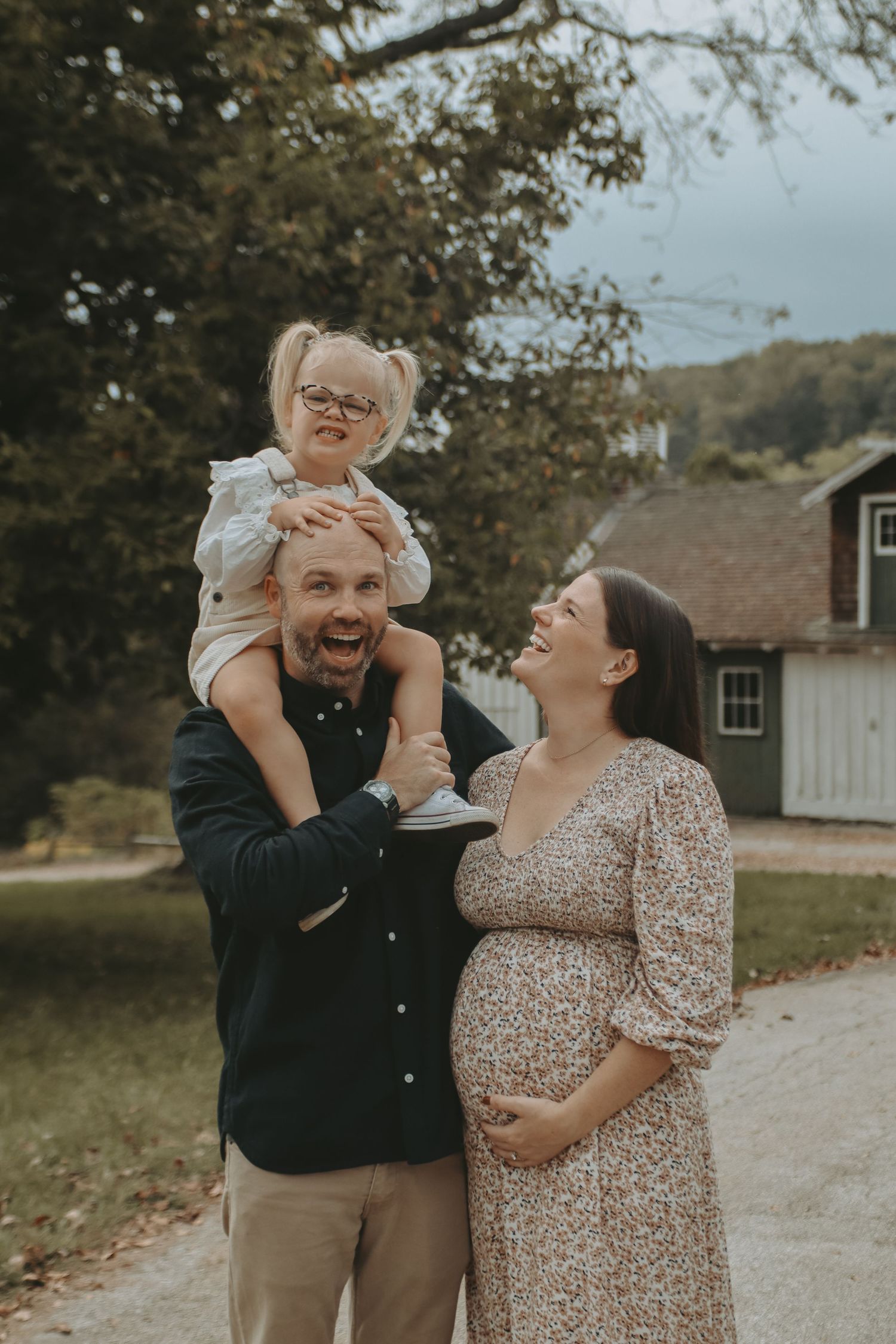A couple shares an intimate moment in a field with floral and muted tones.