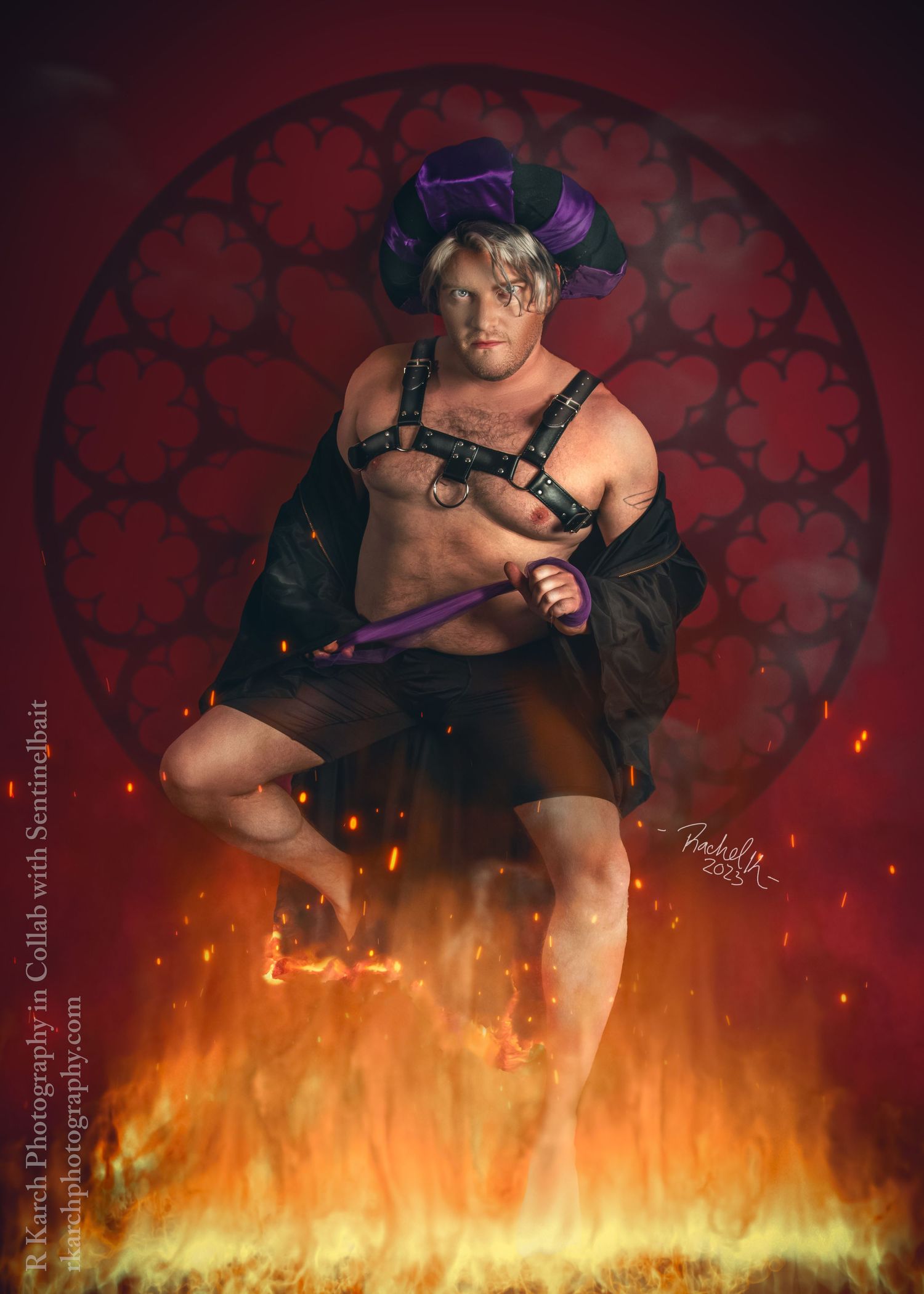 Cosplayer in dramatic fantasy costume poses against red background with flames and dramatic lighting effects.