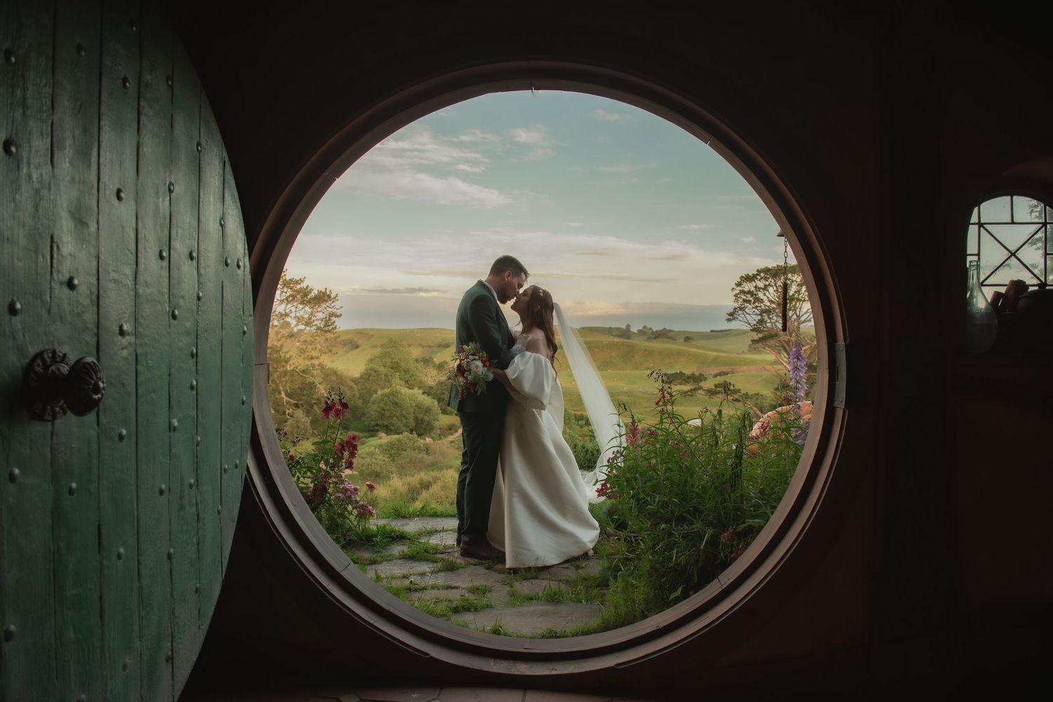 Romantic wedding couple sharing an intimate sunlit kiss in classic formal attire Auckland New Zealand