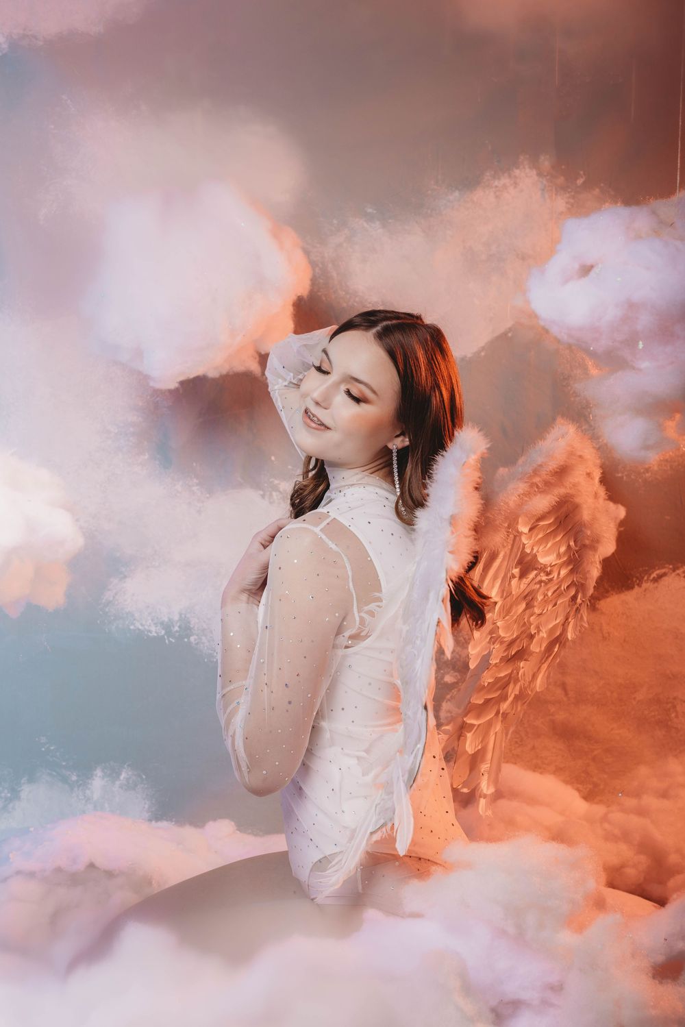 A dreamy portrait series with soft pink and orange clouds creating an ethereal atmosphere.