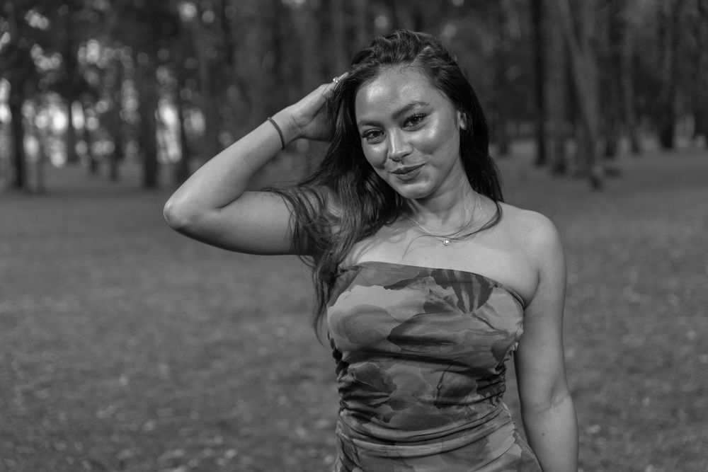 A set of candid outdoor photos showing a person in motion while wearing casual wear in a wooded park setting.