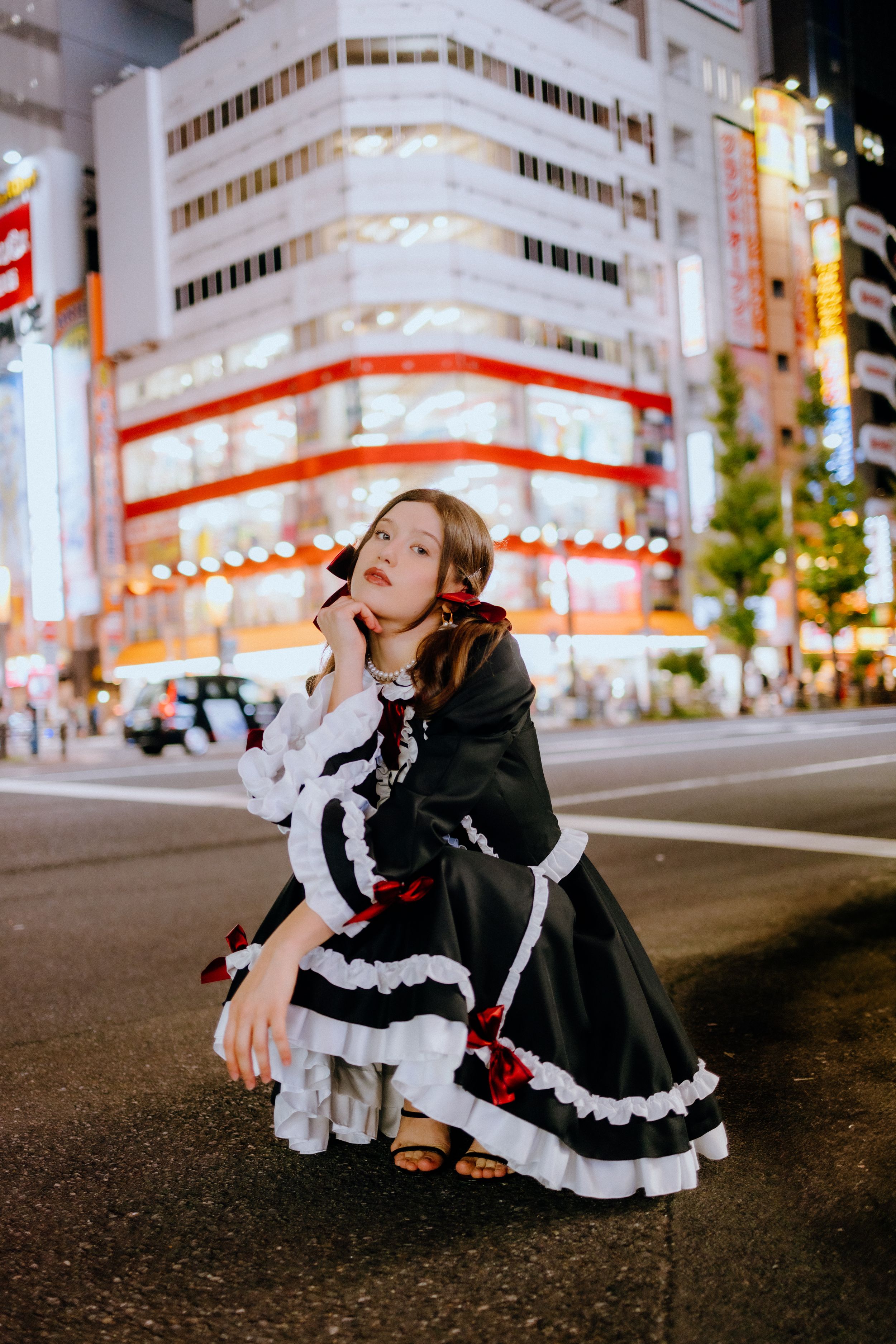Black and white Lolita dress styled shoot in Tokyo's nighttime streets.