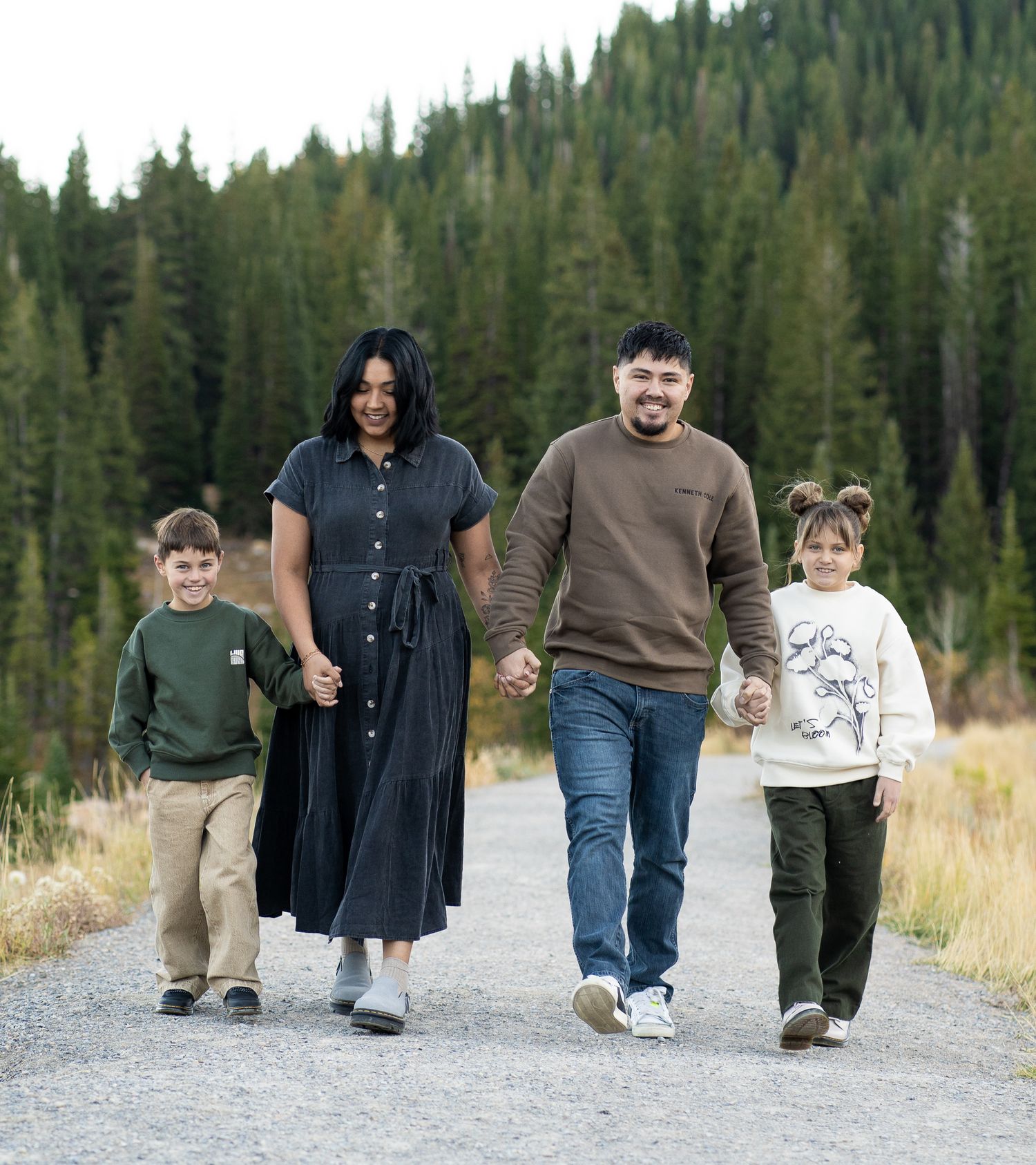 Fall family photography session in Logan Canyon, Utah. A family of four poses in a scenic forest with fall colors at tony's grove.