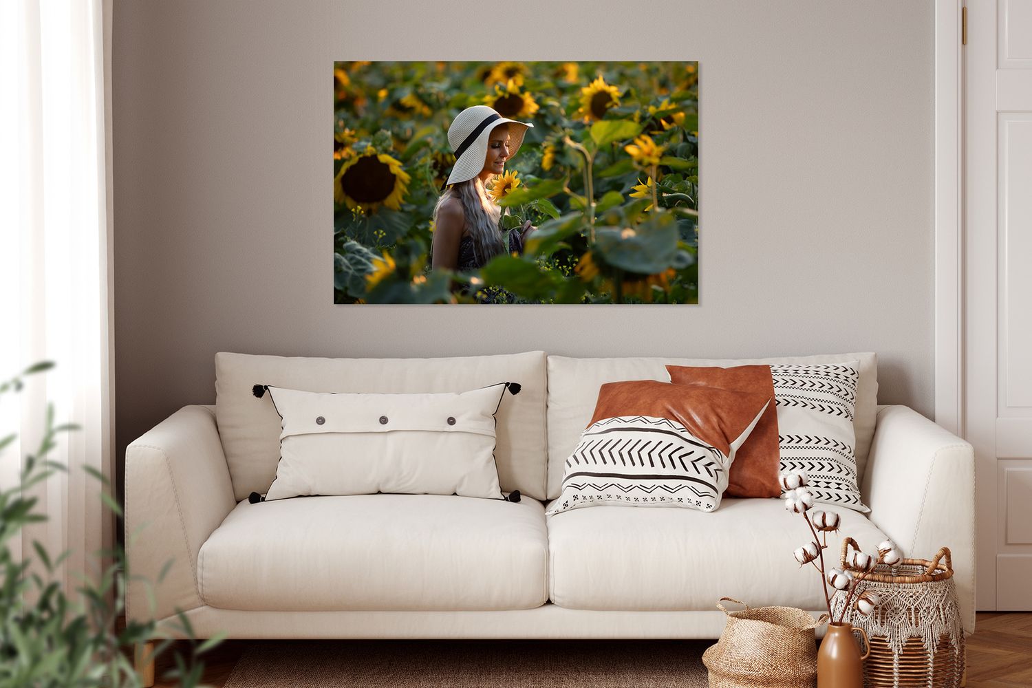 A sunset shot of a pretty blond woman wearing a sunhat, surrounded by a field of sunflowers.