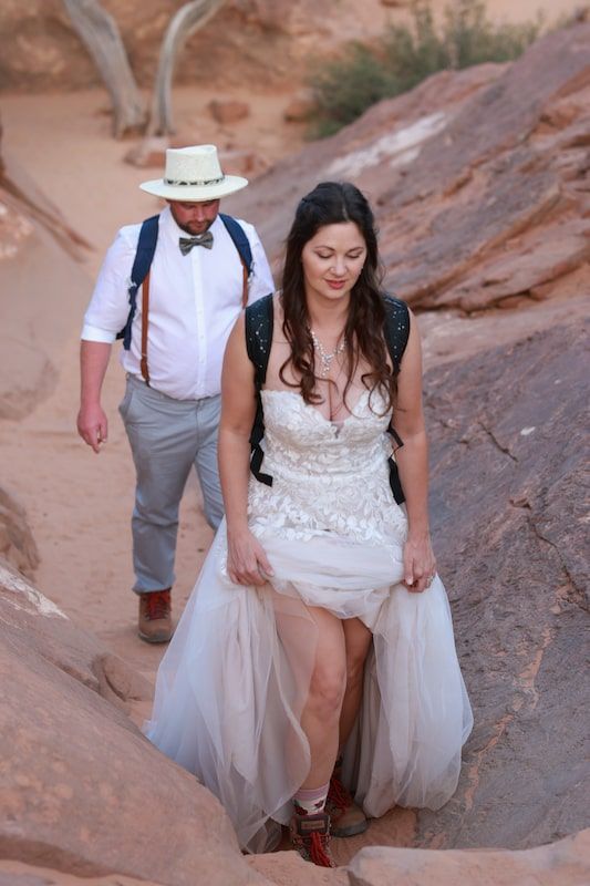 bride hiking in her wedding dress