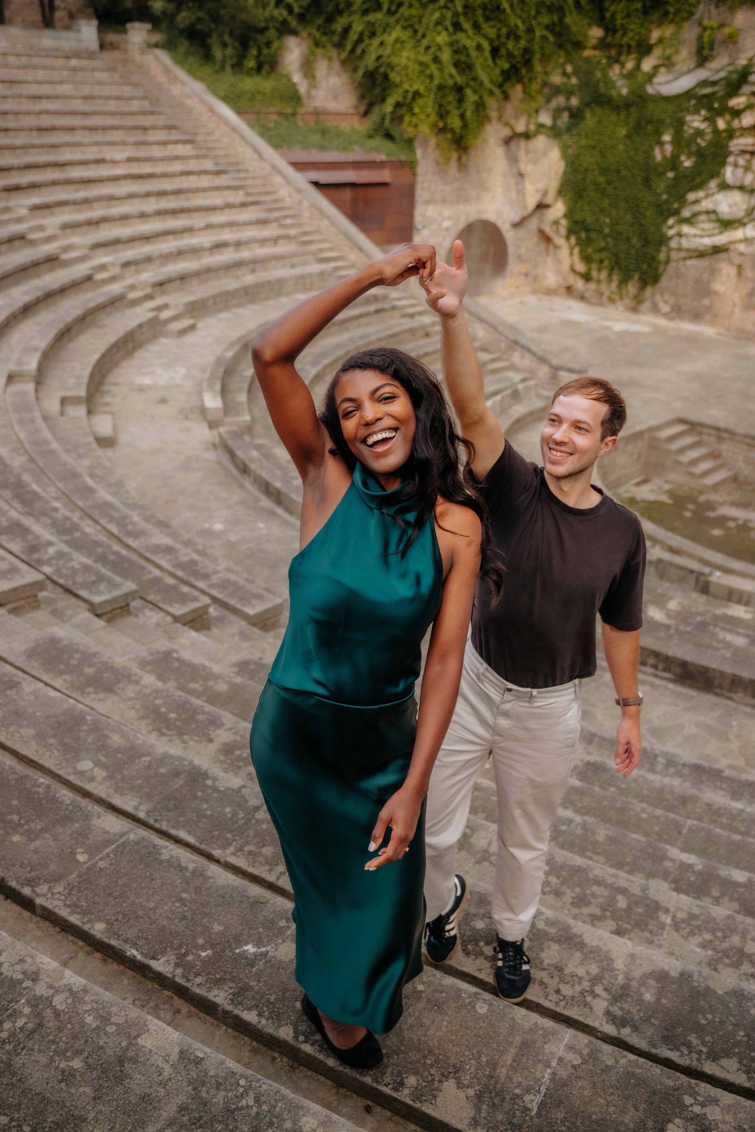 Romantic couple walking through Teatre Grec gardens