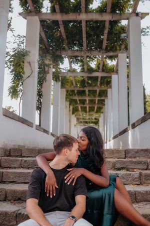 Romantic couple sitting in Teatre Grec stone seating