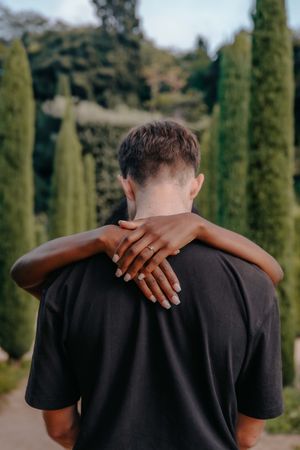 Romantic couple embracing at Teatre Grec with garden views