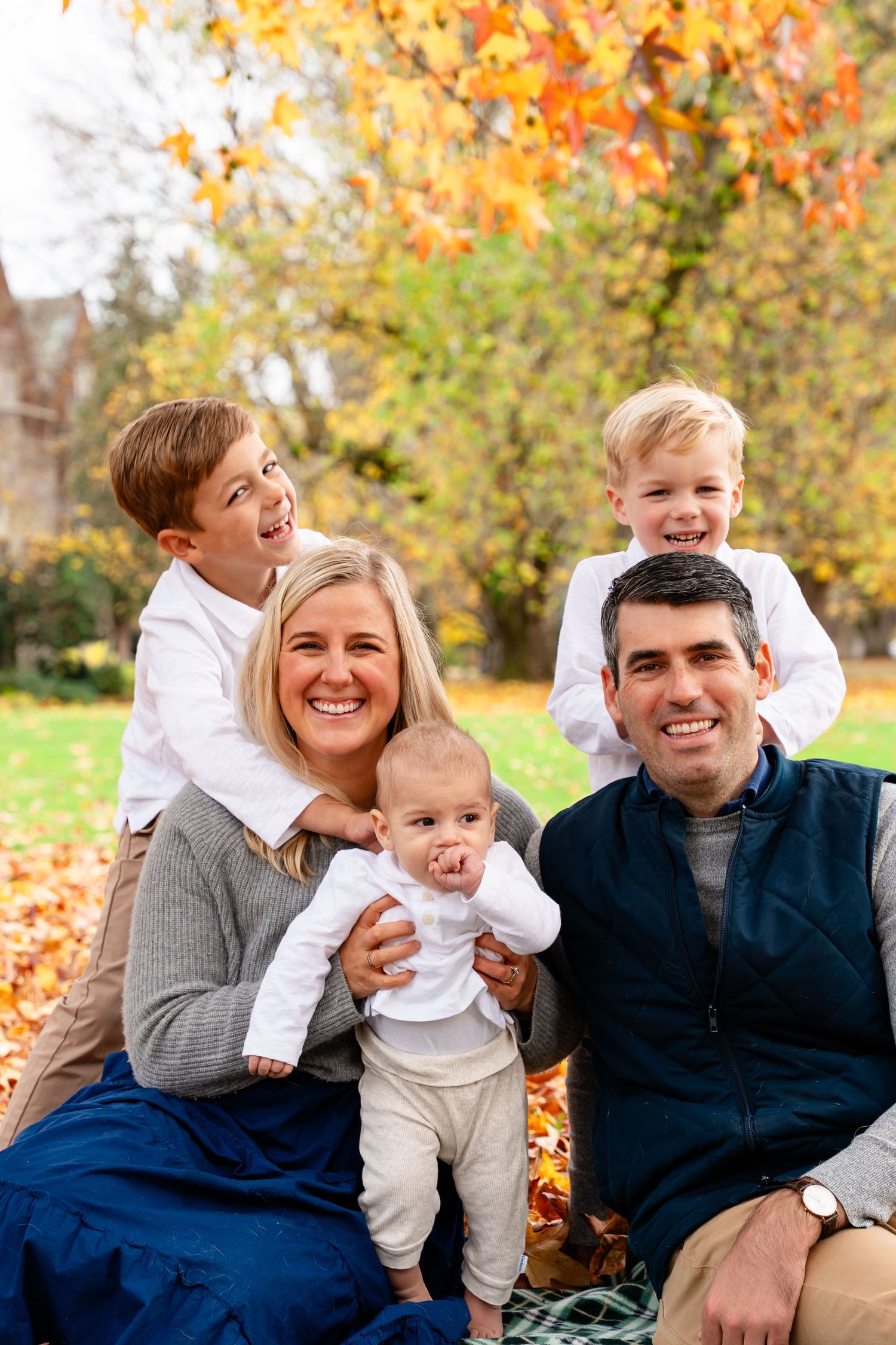 A candid moment of a young family laughing during photoshoot at Reed College Portland Oregon