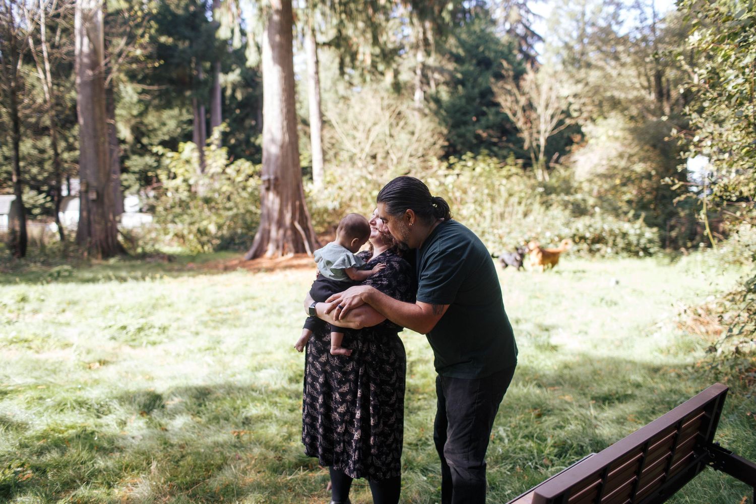 Young parents with their baby at a family photo in their backyard in Seattle WA area