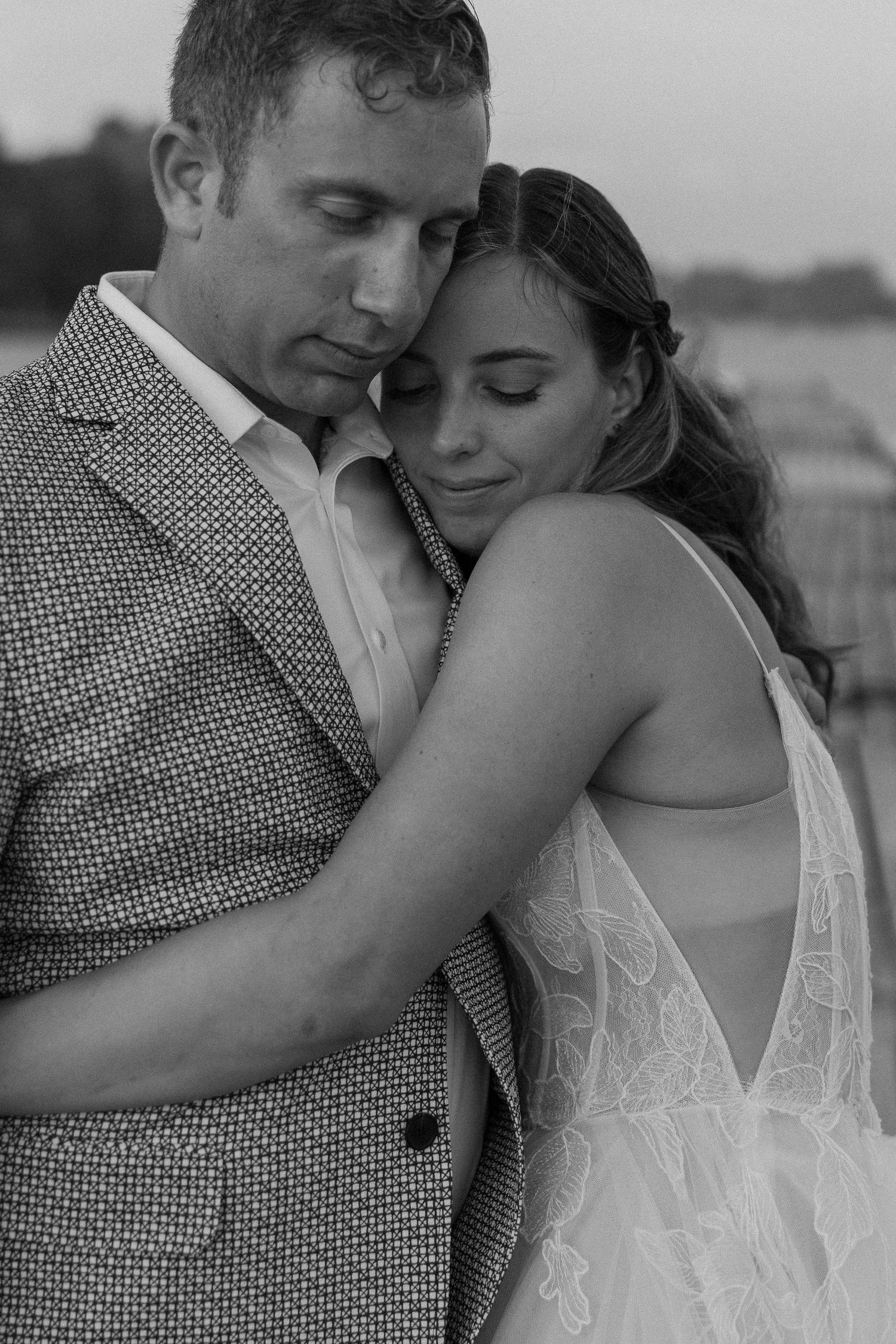 Intimate black and white portrait of couple in formal attire.