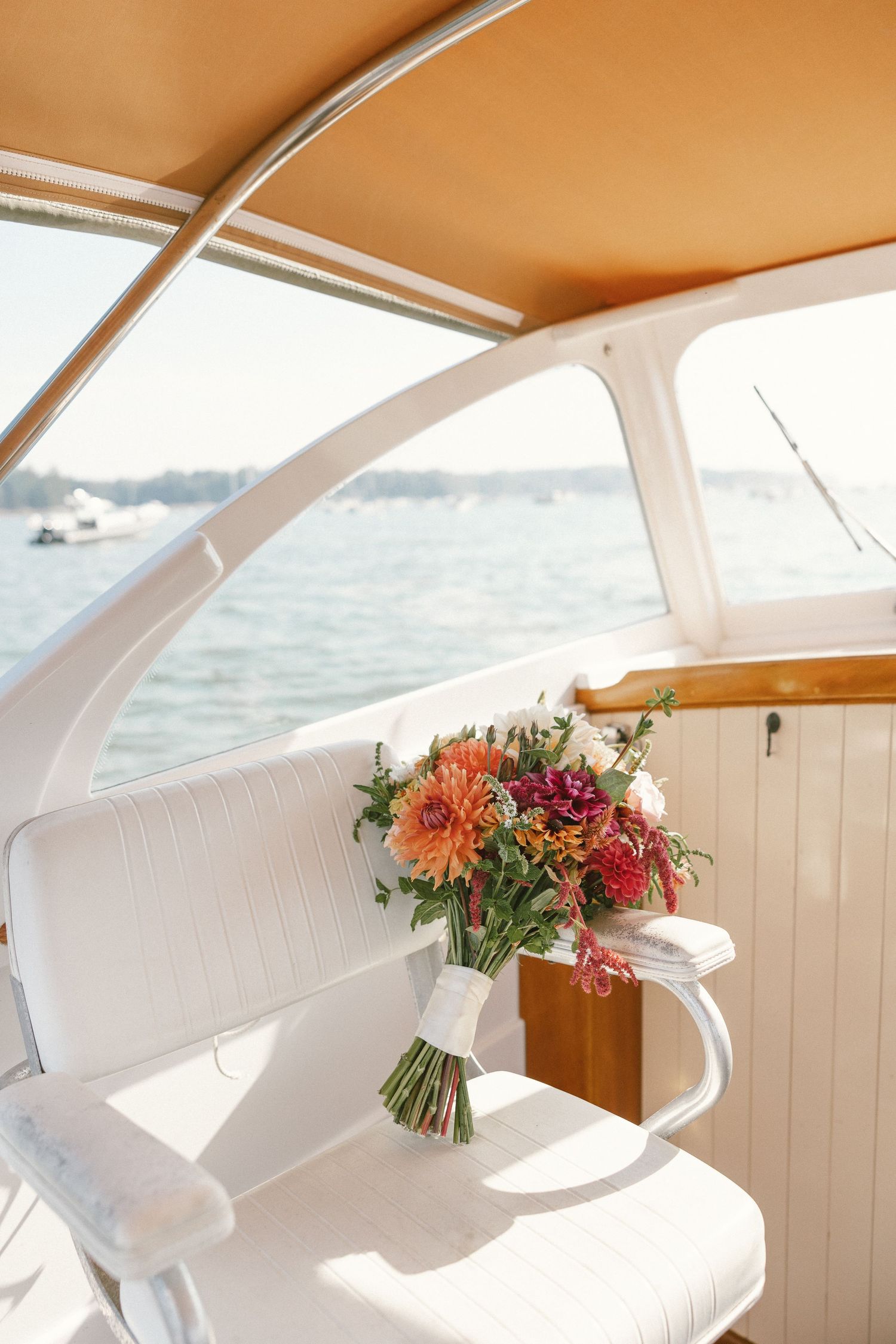 White boat interior with colorful floral arrangements on display.