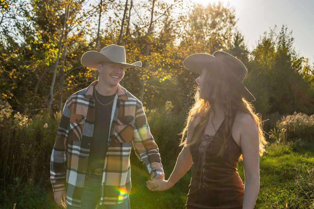Couple walking together in a golden sunset through an outdoor natural setting.