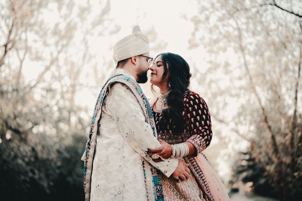 A romantic moment between a couple wearing ornate South Asian wedding outfits. Indian Wedding Photography Toronto GTA