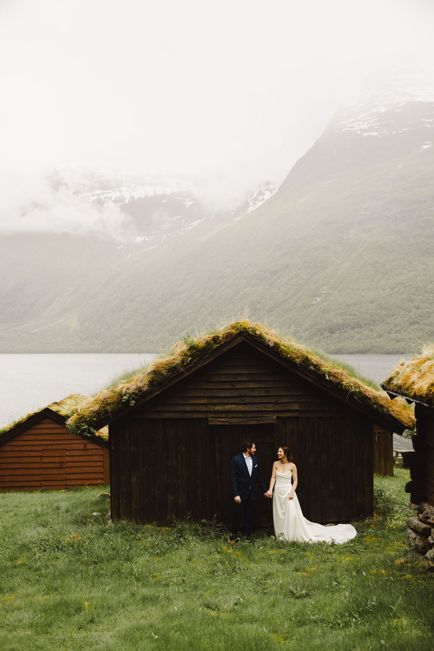 A windy mountaintop wedding moment captured with flowing dress and stunning mountain vistas.