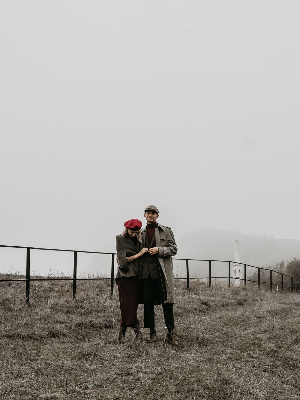 A couple walking in the field, smiling