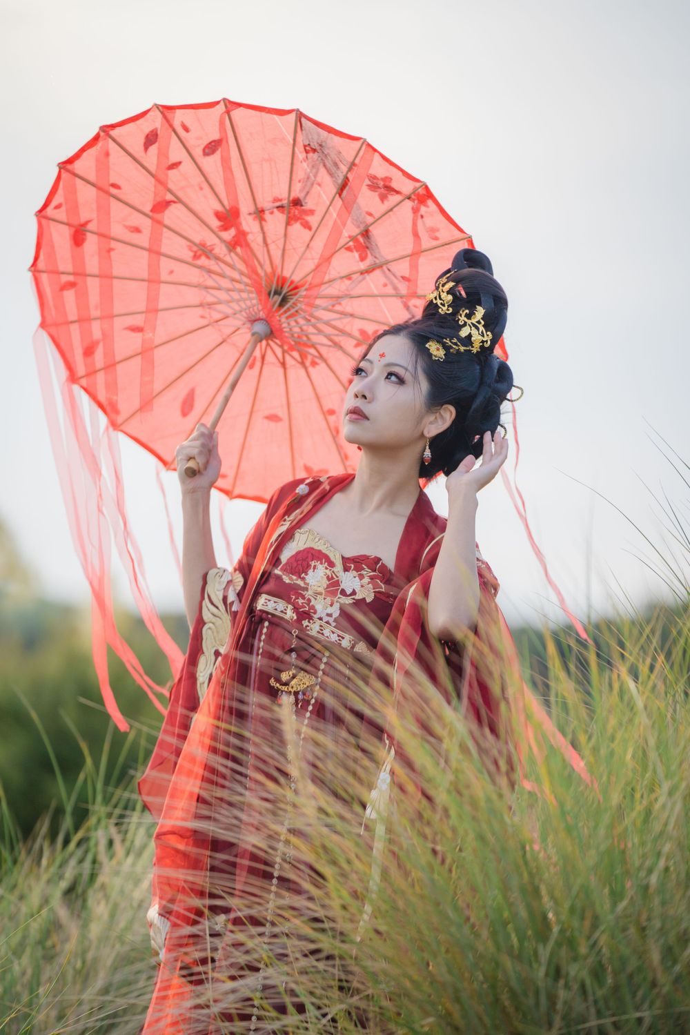 Cinematic solo portrait in flowing red Hanfu at Lake Wainamu sand dunes, evoking a fateful Desert Princess vibe, by Imagine Image Studio.