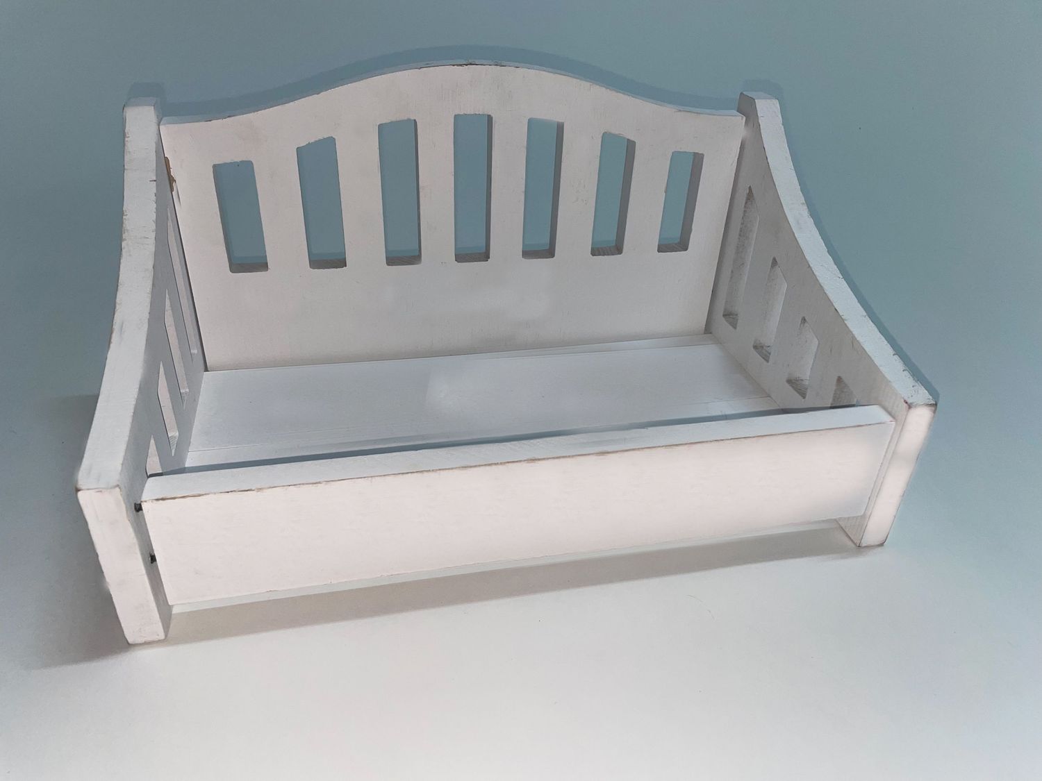 White wooden headboard or bench back with slats shown from different angles.