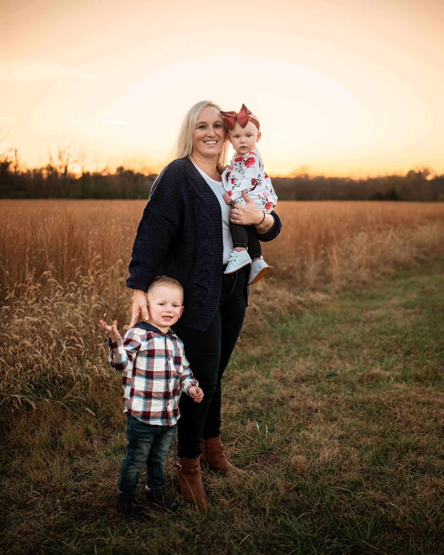 Sunset family photo session in autumn field with golden light.