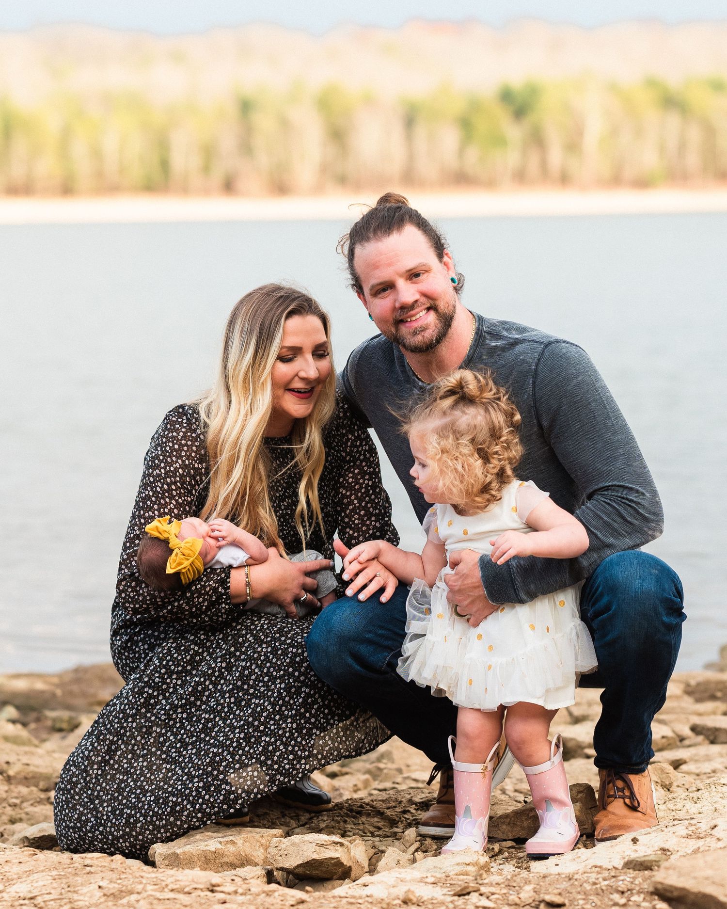 Family shares intimate moments during beachside photo session at sunset.