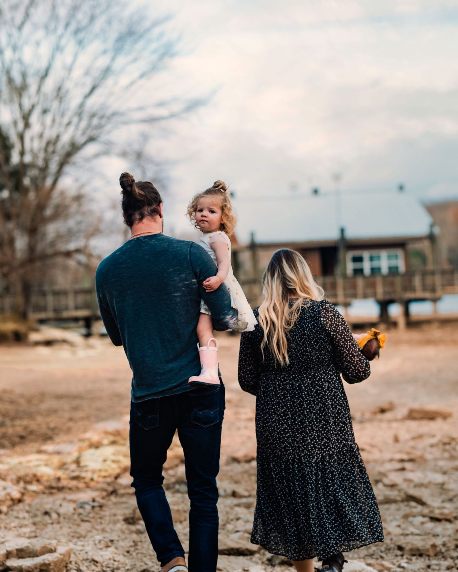 Family walking together on autumn day captured from behind.