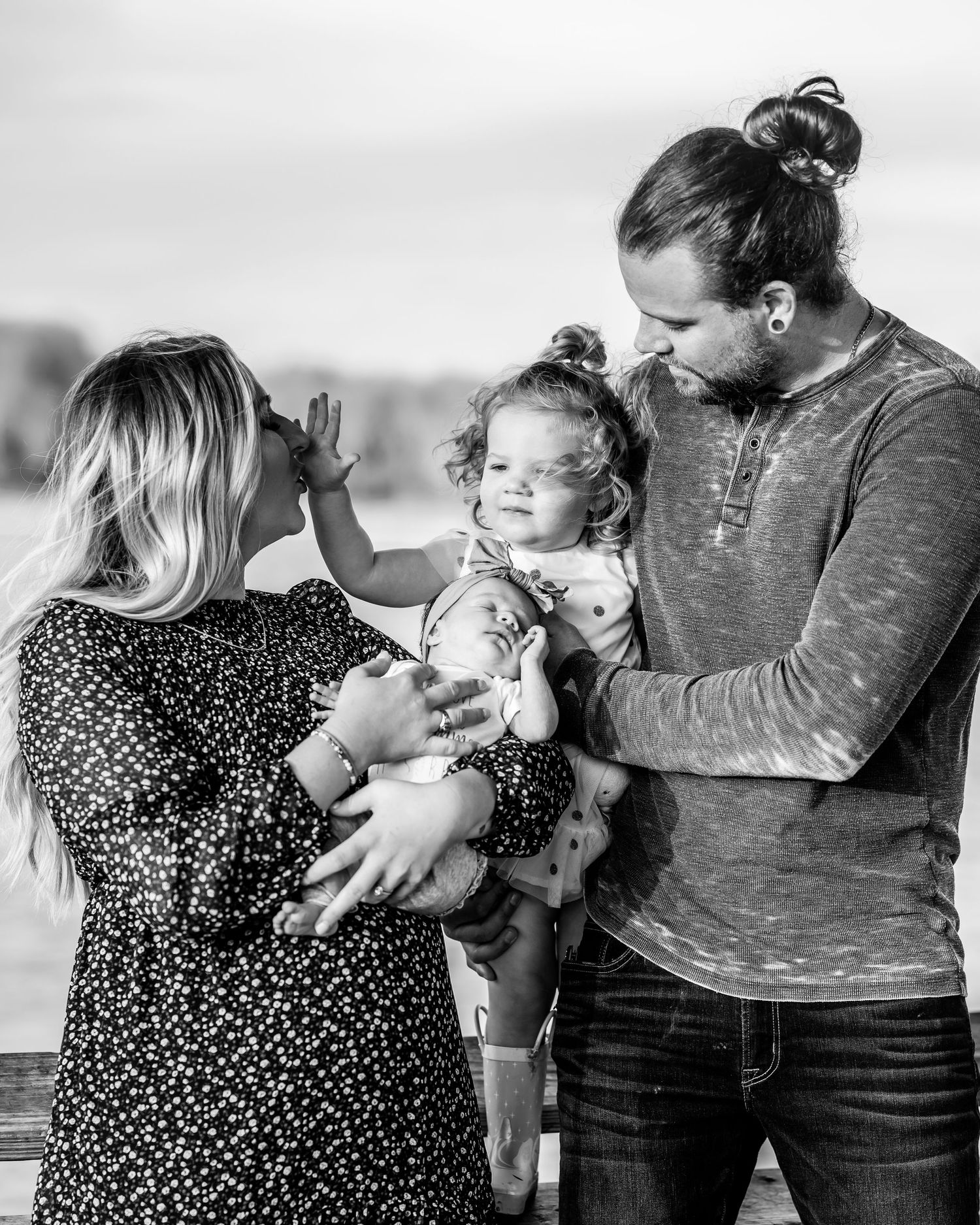 Black and white series of tender family moments outdoors.