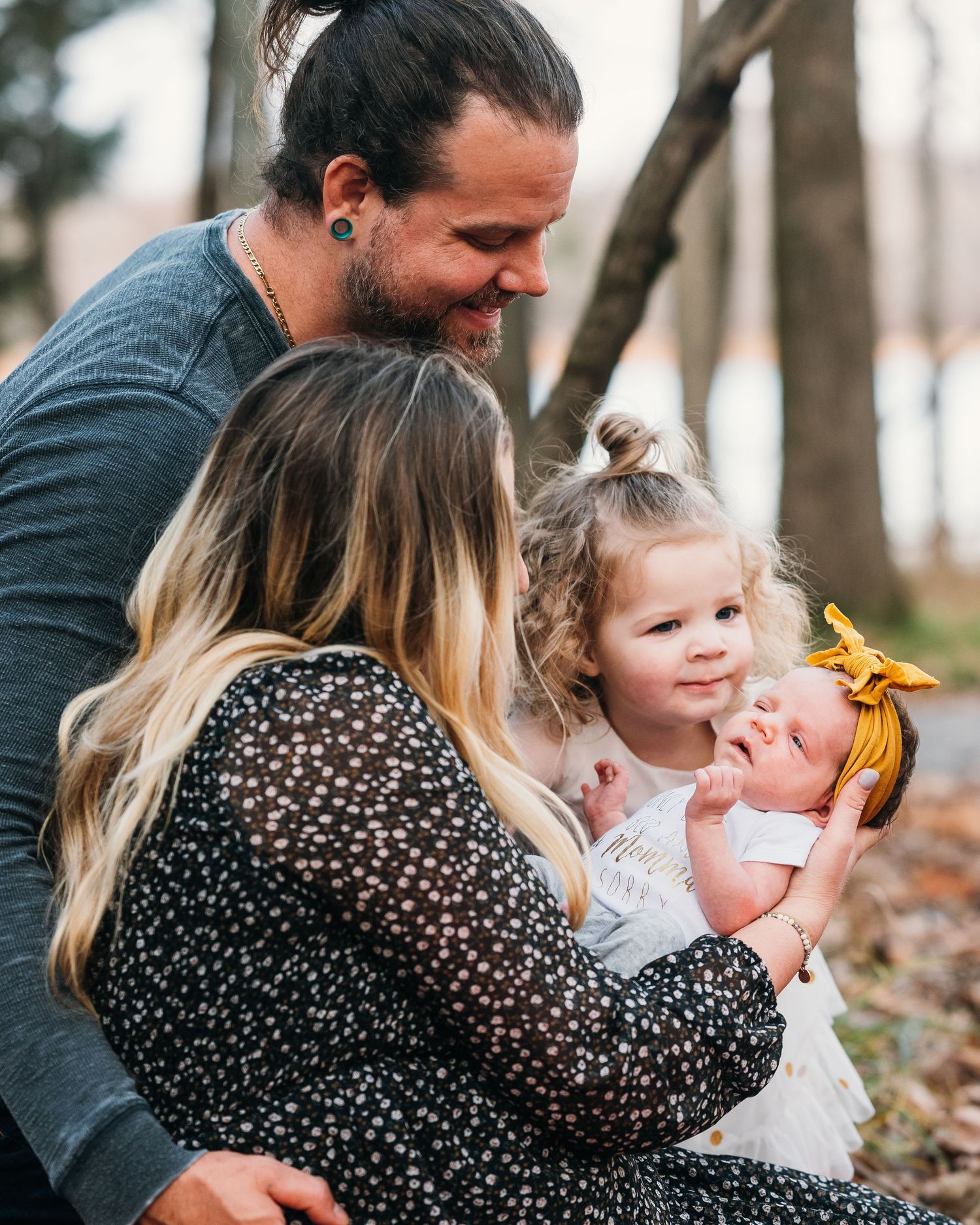 Intimate family moments captured in natural outdoor setting.