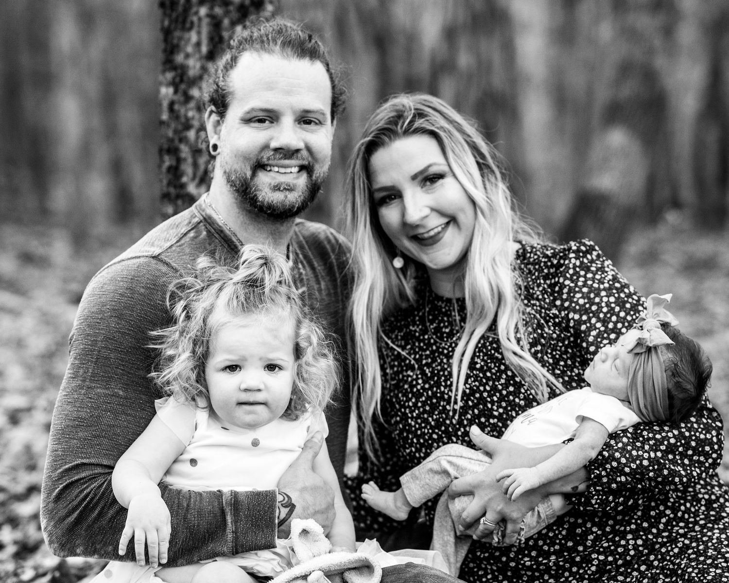 Black and white series of candid family interactions in a forest setting.