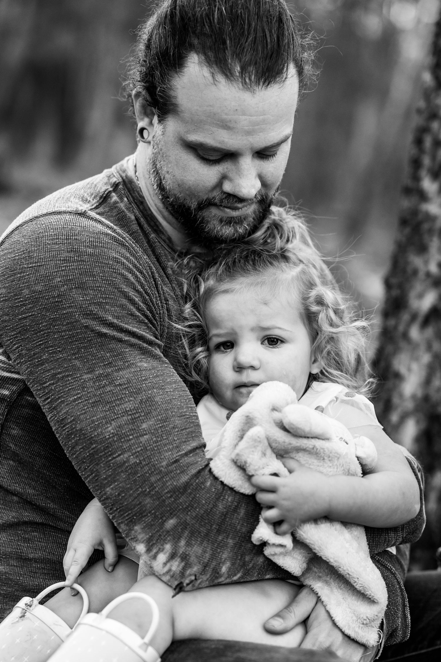 Tender moments captured between parent and child in a series of black and white photographs.