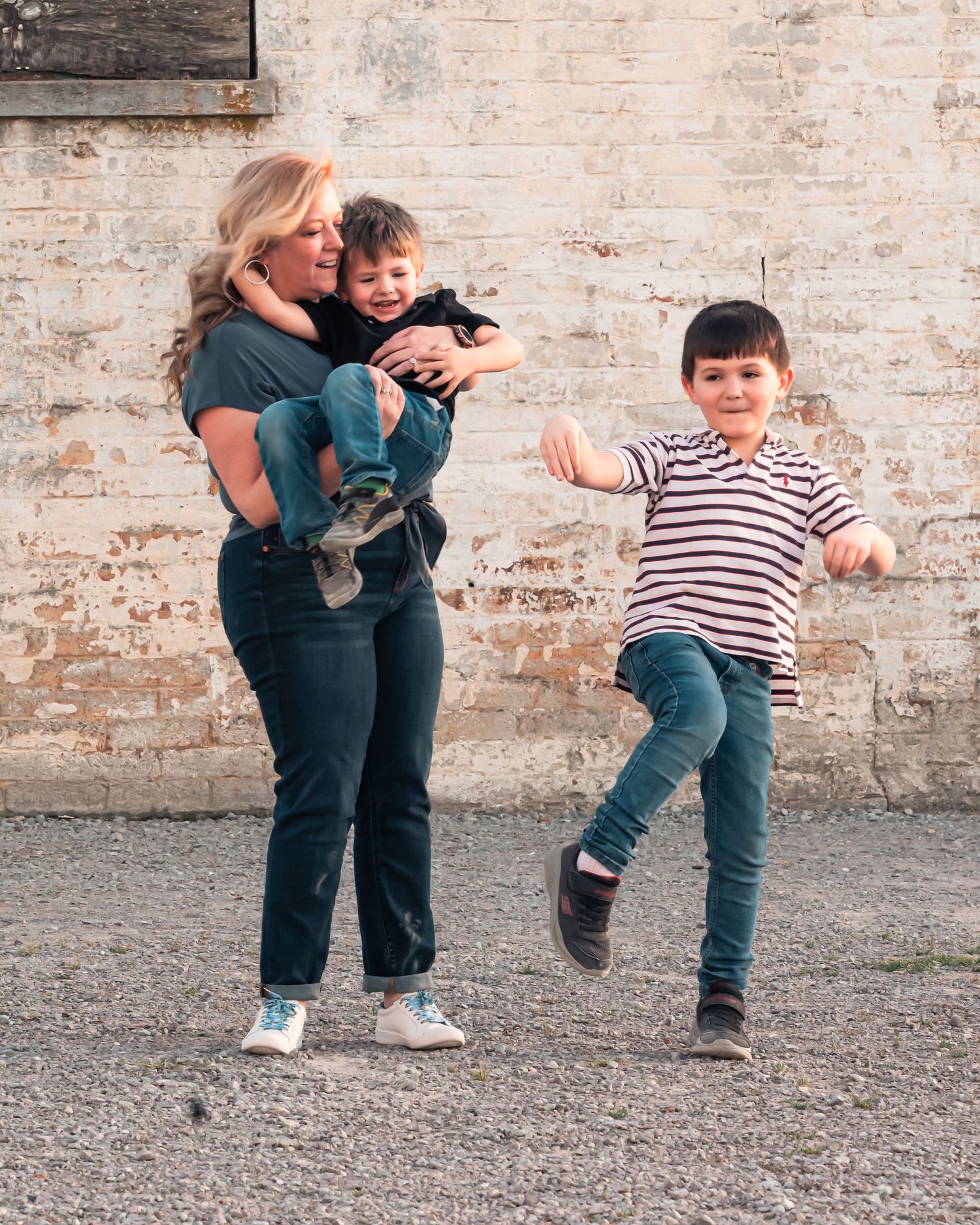 Playful group interaction against rustic brick wall background.