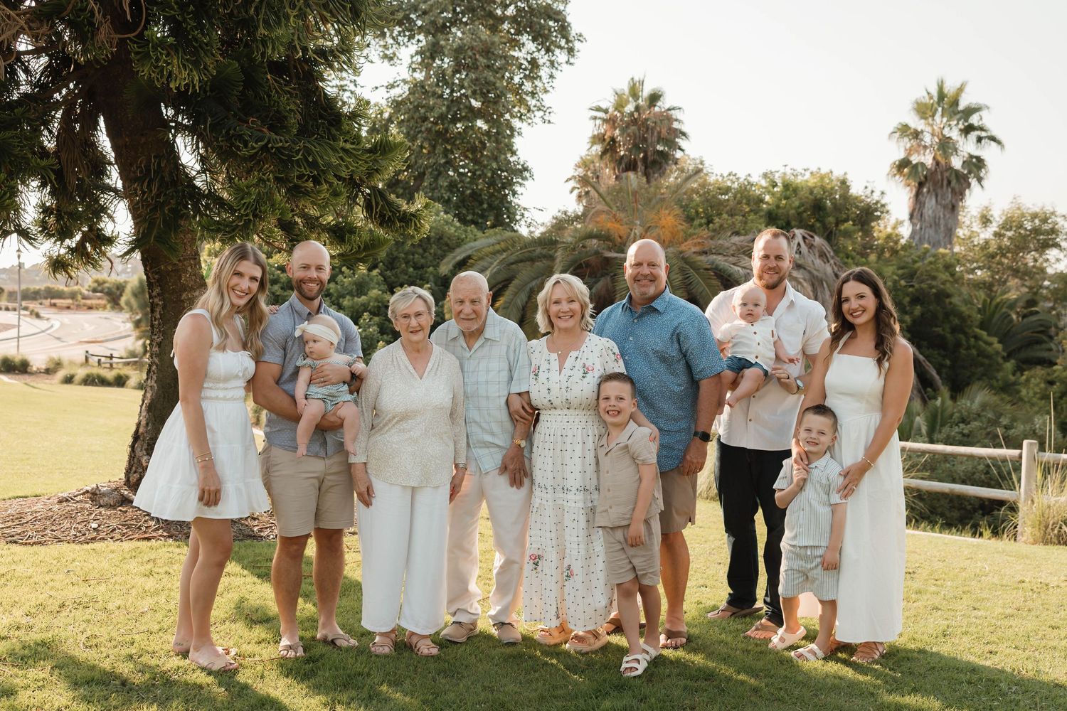 A tender black and white family portrait showing a close embrace outdoors.