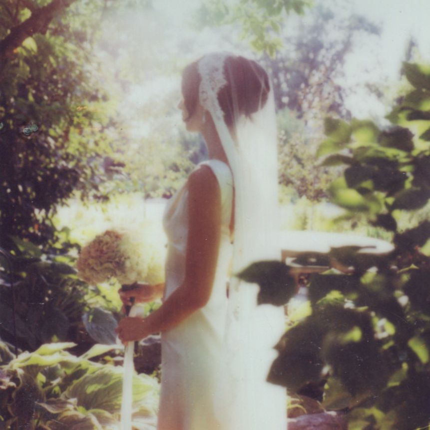 SX-70 film wedding photo of the bride with her florals in provo Utah, beautiful backlit veil caught on film for her wedding day